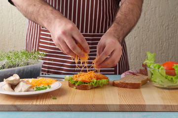 Man cooking big sandwich in home kitchen