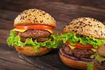 Burgers on a dark wooden rustic background