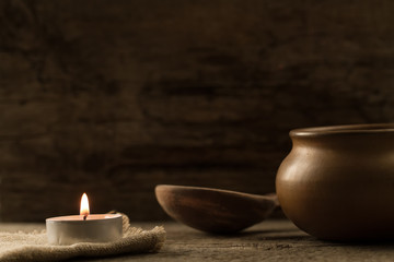 Fototapeta premium light burning brightly candles on old wooden background. Spa, meditation, ritual, flavored.
