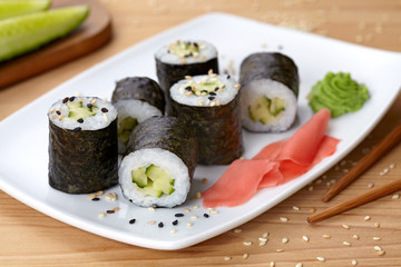 Maki sushi roll with cucumber, wasabi, ginger and nori seaweed. 