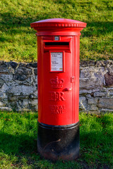 A rural British red traditional Royal Mail pillar box. In Wymeswold, England on 15th January 2016.