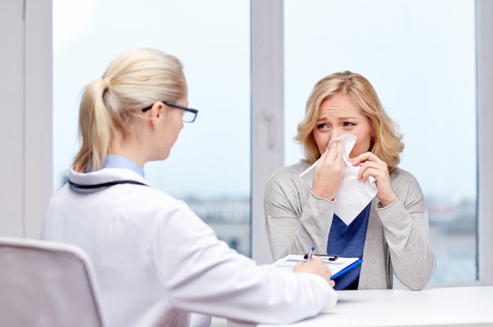 doctor and ill woman patient with flu at clinic