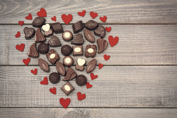 Big heart full of chocolate candies.