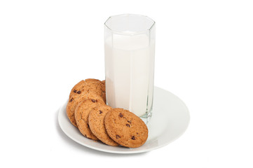 Oat cookies in plate and milk in tall glass isolated on white ba