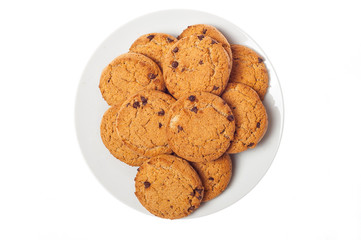 Oat cookies in plate isolated on white background, top view