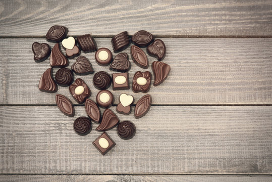 Love symbol full of chocolate candies.