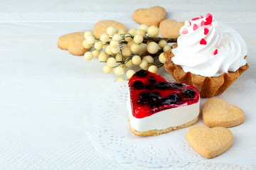 Obraz na płótnie Canvas cake with jam and cookies in the shape of heart on wooden table