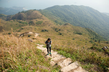Asian Woman hiking to the top of the mountain