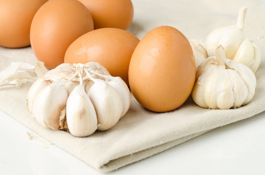 Eggs and garlic on fabric background (food ingredient)