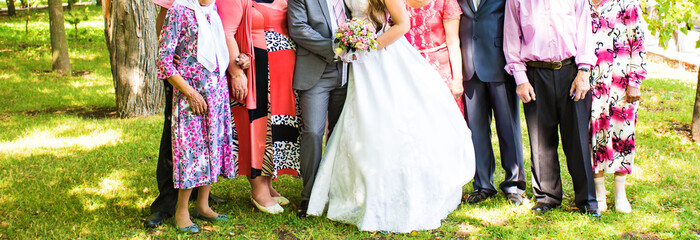  bride and groom standing with guests in garden