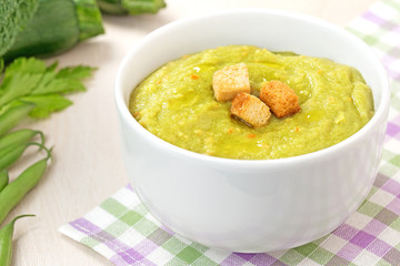 vegetable soup with croutons on checkered napkin