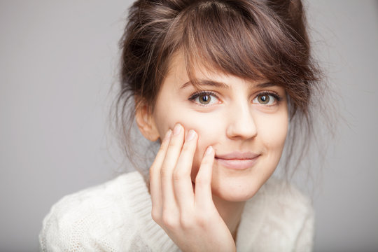 Close up portrait of young smiling brunette woman