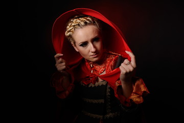 beautiful woman with red cloak posing in studio