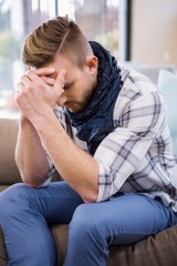 Worried man thinking on the couch 