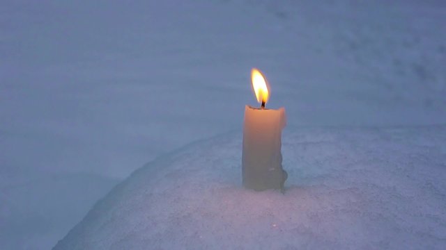 Candle on snow