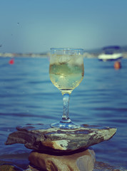 Glass of white wine by the coast