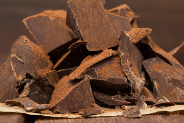 Dark chocolate with cacao on wooden table