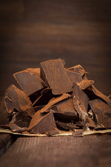 Dark chocolate with cacao on wooden table