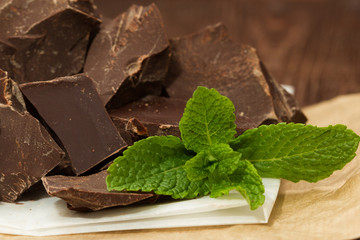 Dark chocolate with cacao on wooden table