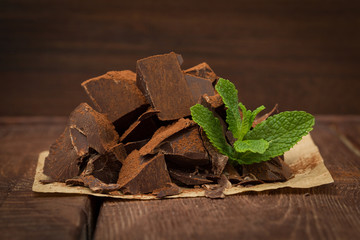 Dark chocolate with cacao on wooden table