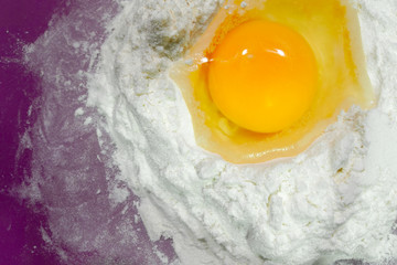 A broken egg in flour