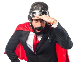 Super hero businessman showing something