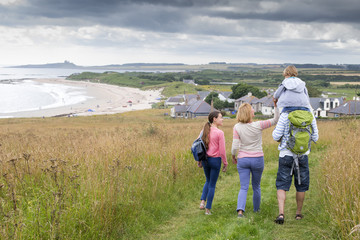 Fototapeta na wymiar Family walking on the sand dunes