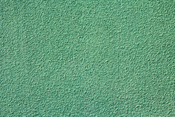 Green stucco relief on the wall of the house. Backgrounds and textures