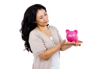 Happy woman holding a piggy bank