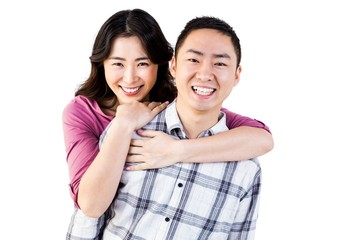 Smiling man gives girl a piggy back