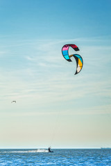 Kite-surfing on the background of blue sea