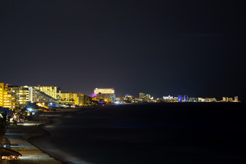 Fototapeta premium Seaside resorts along the coastline in the dark