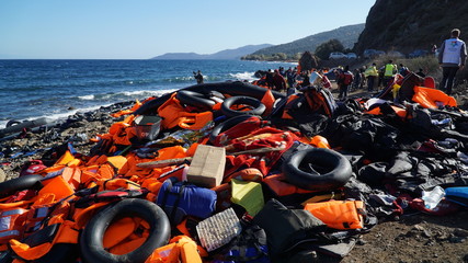 Abandoned belongings and life jackets on the shore