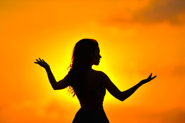 young woman silhouette at sunset