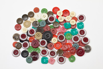 heap sewing color buttons on white