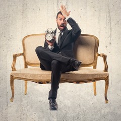 Businessman holding vintage clock