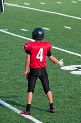 American high school football player with thumbs up on the field