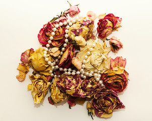 composition of dry bouquet with roses and pearl beads