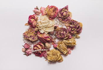 composition of dry bouquet with roses and pearl beads