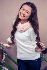 Asian woman holding bike
