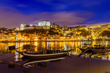 old town cityscape on the Douro River with traditional Rabelo boats, Porto, Portugal.