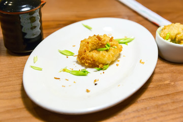 The remains of squid in batter. The remains of a sumptuous dinne