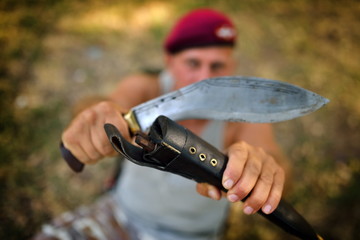 man holding old knife