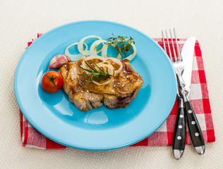 Juicy pork chop with onion rings