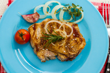 Grilled pork chop with onion rings