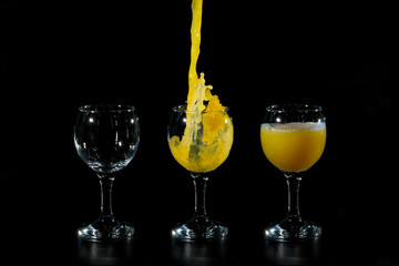 Three glass cups of orange juice
