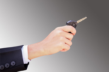 Business man smiling showing key