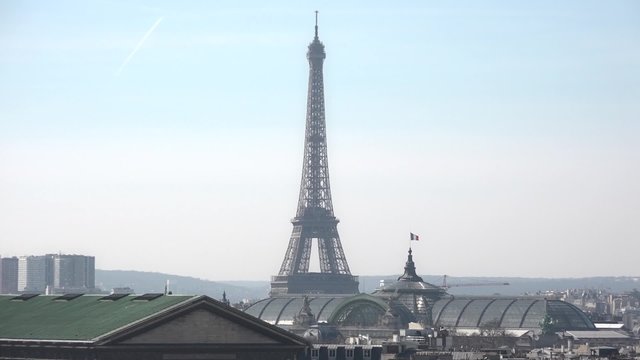 Eiffel Tower and Grand Palais des Champs-Elysees, Paris - Full HD. Still shot of the Eiffel Tower and the Grand Palais des Champs-Élysées. View from the roofs. 1080p - 60fps