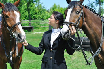 Obraz premium young horsewoman with two horse