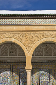 Tunisia. Kairouan - the Zaouia of Sidi Saheb. Fragment of courtyard with decorative arches and wal covered ornamental tiles